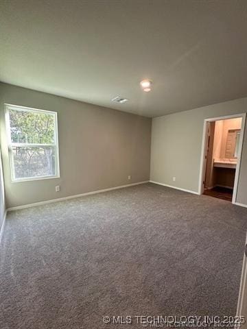 1405 E 83rd St, Broken Arrow, OK 74014 - spare room with dark colored carpet