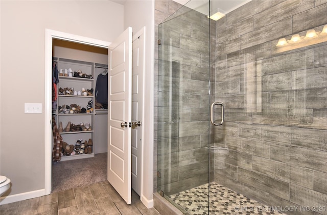 10718 S 279th Ave E, Coweta, OK 74429 - full bath with a shower stall, a spacious closet, and wood finished floors