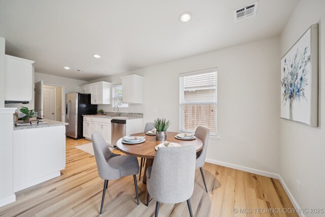 2211 E Concord Pl, Broken Arrow, OK 74012 - dining space with light wood-style flooring and recessed lighting