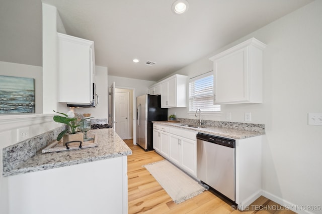 2211 E Concord Pl, Broken Arrow, OK 74012 - kitchen featuring appliances with stainless steel finishes, white cabinetry, light wood-style floors, recessed lighting, and light stone counters