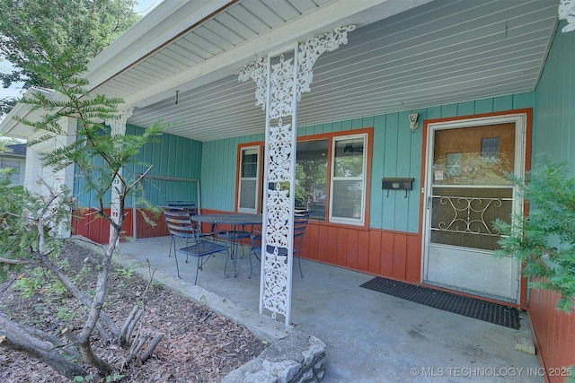 583 S Joplin Ave, Tulsa, OK 74112 - property entrance with board and batten siding and a patio