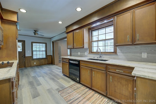 583 S Joplin Ave, Tulsa, OK 74112 - kitchen with black appliances, brown cabinets, light wood finished floors, ceiling fan, and a wainscoted wall