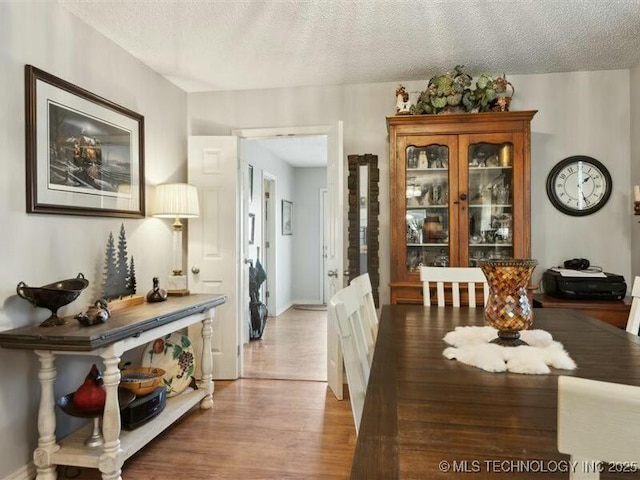 31990 S 624th Pl Unit 48, Grove, OK 74344 - dining space featuring light wood-type flooring and a textured ceiling
