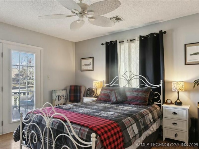 31990 S 624th Pl Unit 48, Grove, OK 74344 - bedroom featuring a textured ceiling, ceiling fan, and wood finished floors