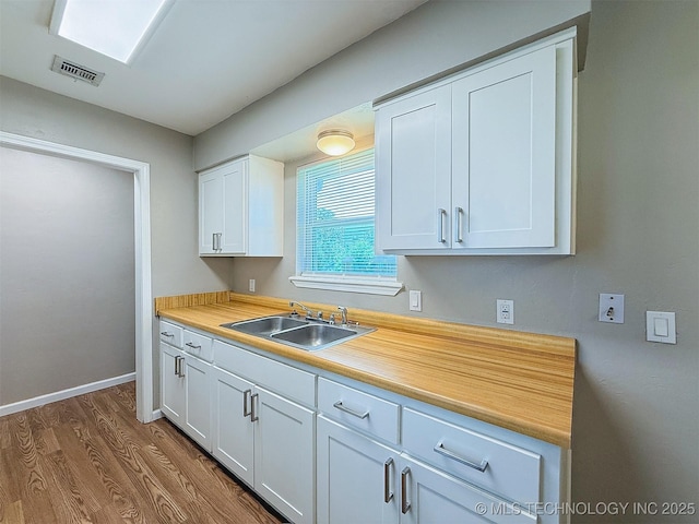 3700 Bloomfield Loop, Ada, OK 74820 - kitchen featuring white cabinets, light countertops, and dark wood-style flooring