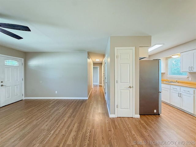 3700 Bloomfield Loop, Ada, OK 74820 - unfurnished living room with a ceiling fan and light wood-style flooring