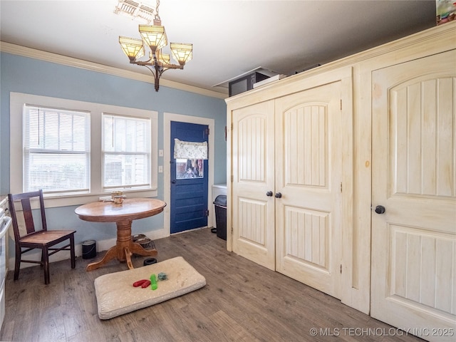 621 E Seminole Ave, Mcalester, OK 74501 - dining space featuring a chandelier, wood finished floors, and crown molding