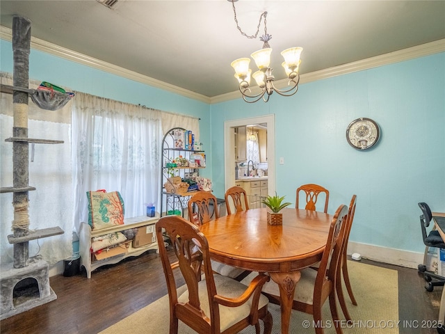 621 E Seminole Ave, Mcalester, OK 74501 - dining space featuring a chandelier, crown molding, and wood finished floors