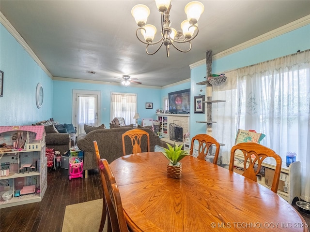 621 E Seminole Ave, Mcalester, OK 74501 - dining space with crown molding, a chandelier, hardwood / wood-style floors, and a stone fireplace