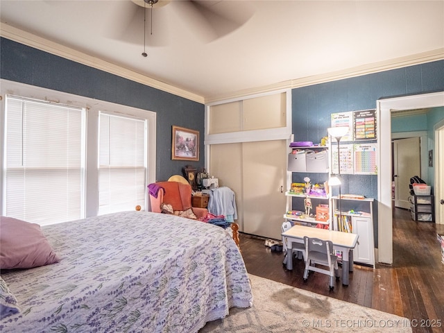 621 E Seminole Ave, Mcalester, OK 74501 - bedroom with wood finished floors, a closet, and ornamental molding