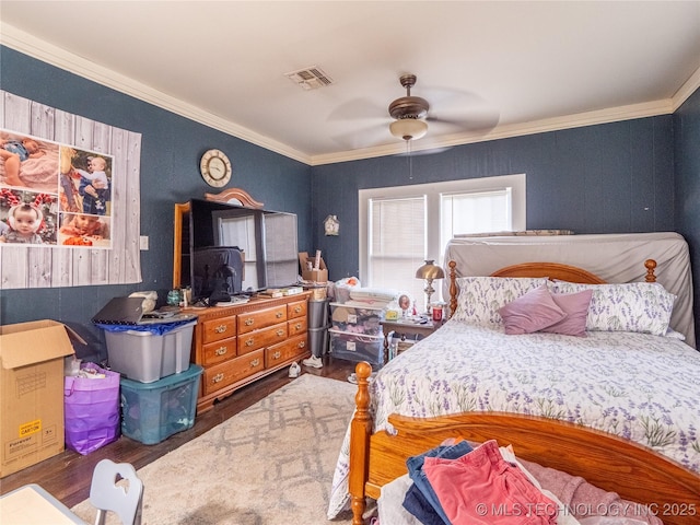 621 E Seminole Ave, Mcalester, OK 74501 - bedroom with wood finished floors, crown molding, and ceiling fan