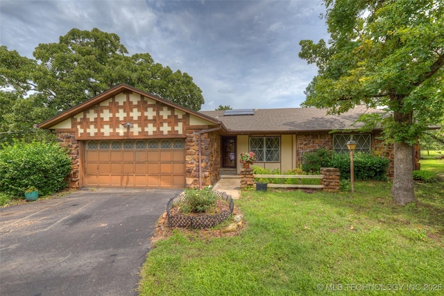 28265 Forest Ridge Rd, Sand Springs, OK 74063 - view of front of home with stone siding, an attached garage, driveway, roof mounted solar panels, and a front yard