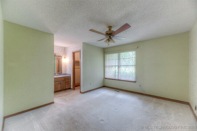 28265 Forest Ridge Rd, Sand Springs, OK 74063 - unfurnished bedroom featuring light colored carpet, a textured ceiling, connected bathroom, and ceiling fan