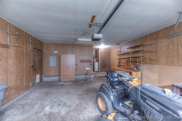 28265 Forest Ridge Rd, Sand Springs, OK 74063 - garage featuring a garage door opener, wooden walls, electric panel, and water heater