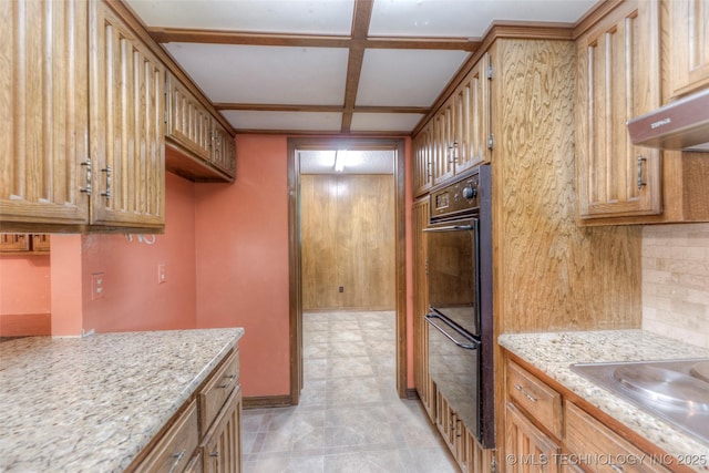 28265 Forest Ridge Rd, Sand Springs, OK 74063 - kitchen featuring coffered ceiling, backsplash, range hood, light stone counters, and brown cabinetry