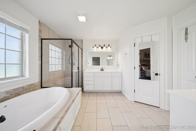 5814 130th W Ave, Sand Springs, OK 74063 - bathroom featuring vanity, a stall shower, a bath, and plenty of natural light