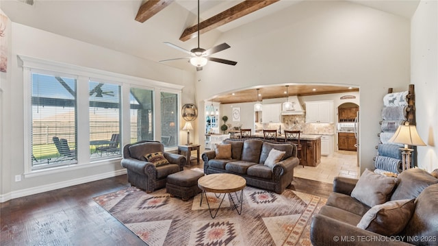 14934 S Sequoia St, Glenpool, OK 74033 - living room featuring arched walkways, beamed ceiling, a ceiling fan, high vaulted ceiling, and light wood-style floors