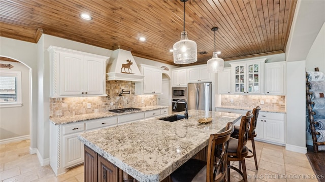 14934 S Sequoia St, Glenpool, OK 74033 - kitchen featuring appliances with stainless steel finishes, custom exhaust hood, wooden ceiling, arched walkways, and tasteful backsplash