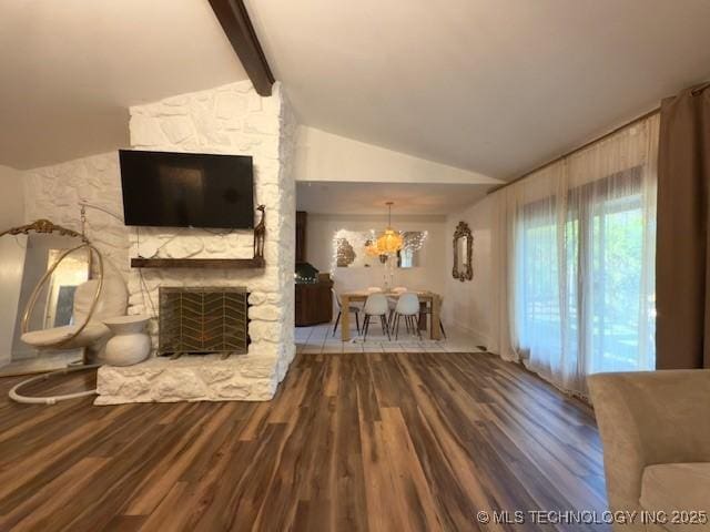 104 E 58th St, Tulsa, OK 74105 - living room with a stone fireplace, wood finished floors, and a chandelier