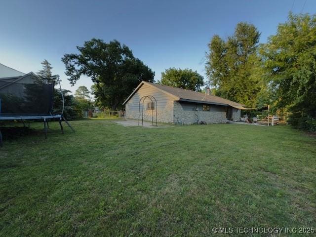 104 E 58th St, Tulsa, OK 74105 - view of grassy yard with a trampoline