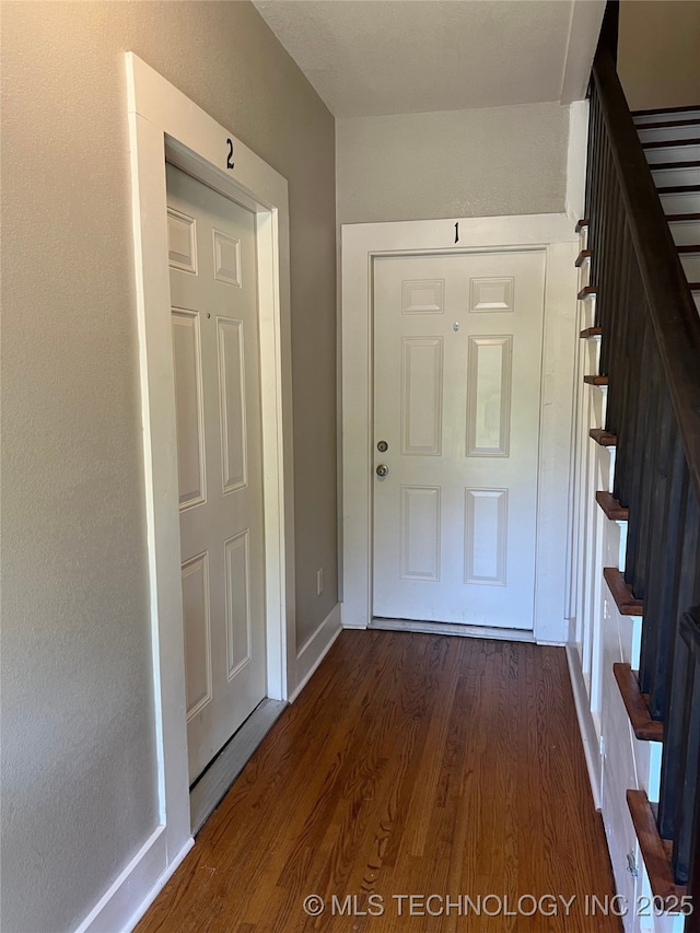 1215 S Quincy Ave, Tulsa, OK 74120 - doorway featuring dark wood-style flooring and stairs