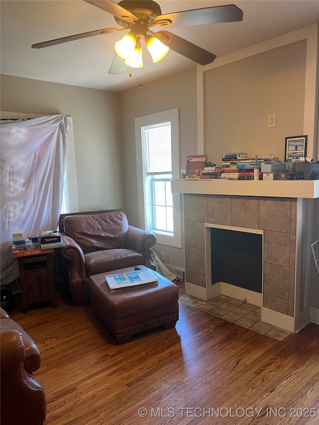 1215 S Quincy Ave, Tulsa, OK 74120 - living area with wood finished floors, a ceiling fan, and a fireplace