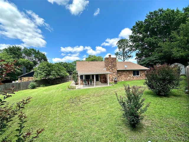 204 E 24th Ct, Owasso, OK 74055 - rear view of property featuring a patio area, stone siding, and a chimney