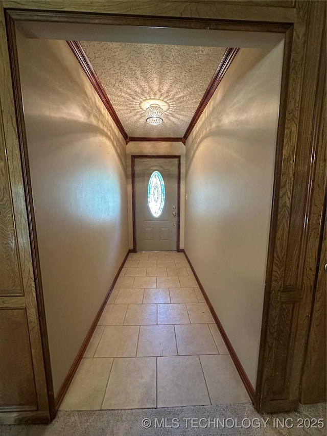 204 E 24th Ct, Owasso, OK 74055 - entryway featuring ornamental molding, light tile patterned floors, and a textured ceiling