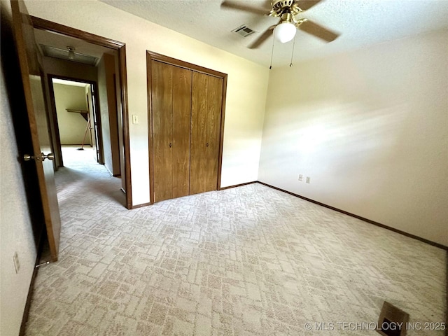 204 E 24th Ct, Owasso, OK 74055 - unfurnished bedroom with carpet, a closet, and a ceiling fan