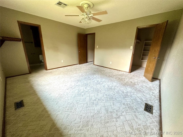 204 E 24th Ct, Owasso, OK 74055 - unfurnished bedroom with a spacious closet, light carpet, a closet, and ensuite bath