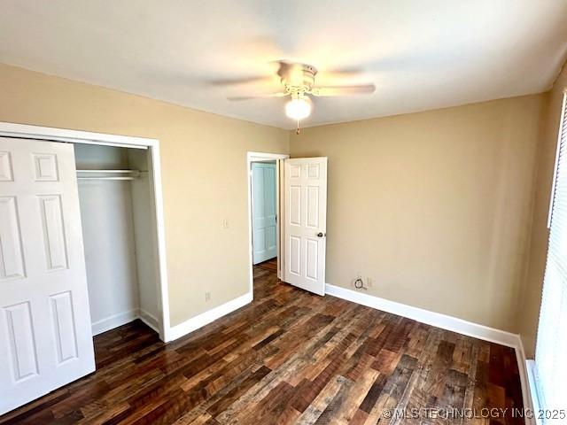 349 S Foreman St, Vinita, OK 74301 - unfurnished bedroom featuring a closet, dark wood-style flooring, and ceiling fan