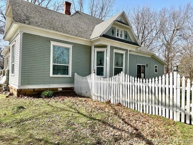 349 S Foreman St, Vinita, OK 74301 - view of side of property featuring a chimney and roof with shingles