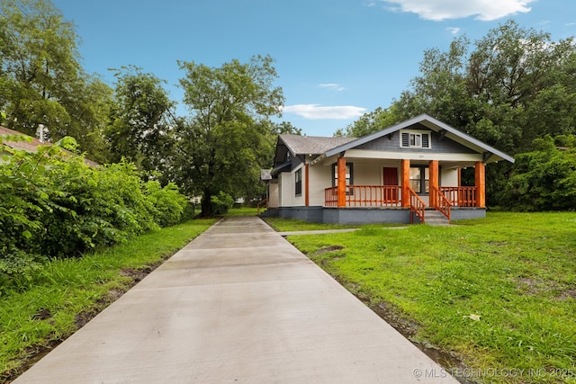 224 E Oklahoma St, Tulsa, OK 74106 - bungalow-style home with covered porch, a front yard, and driveway