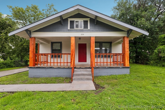 224 E Oklahoma St, Tulsa, OK 74106 - bungalow-style home with covered porch and a front lawn