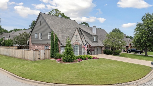 5117 E 92nd St, Tulsa, OK 74137 - view of front facade featuring concrete driveway, brick siding, a chimney, and a shingled roof