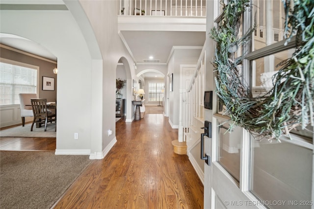 5117 E 92nd St, Tulsa, OK 74137 - entrance foyer featuring crown molding, arched walkways, wood finished floors, and stairs