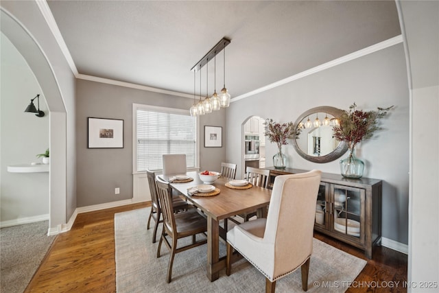 5117 E 92nd St, Tulsa, OK 74137 - dining area with arched walkways, crown molding, wood finished floors, and a chandelier