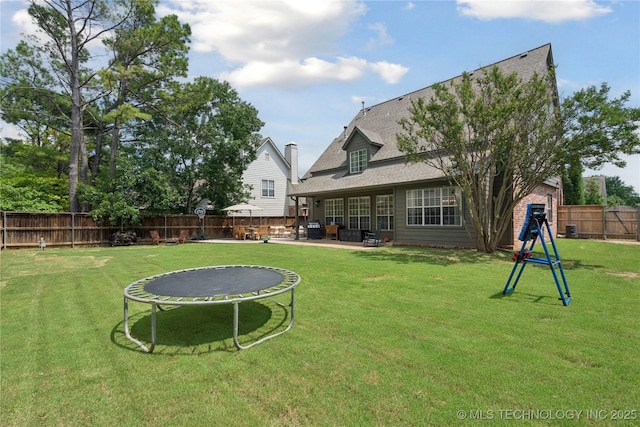 5117 E 92nd St, Tulsa, OK 74137 - fenced backyard with a trampoline and a patio area