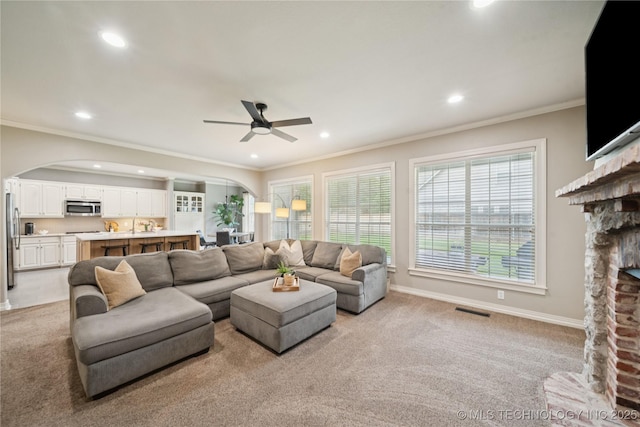5117 E 92nd St, Tulsa, OK 74137 - living area featuring arched walkways, recessed lighting, crown molding, a fireplace, and ceiling fan