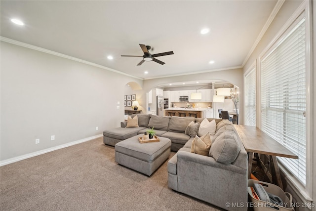 5117 E 92nd St, Tulsa, OK 74137 - carpeted living room with arched walkways, recessed lighting, ceiling fan, and ornamental molding