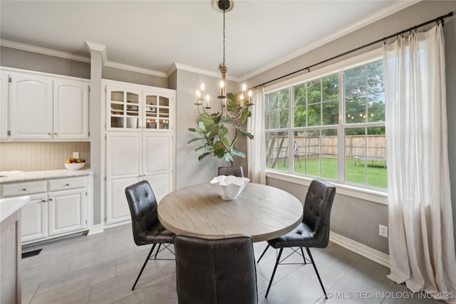 5117 E 92nd St, Tulsa, OK 74137 - dining space featuring ornamental molding, a chandelier, and light tile patterned floors