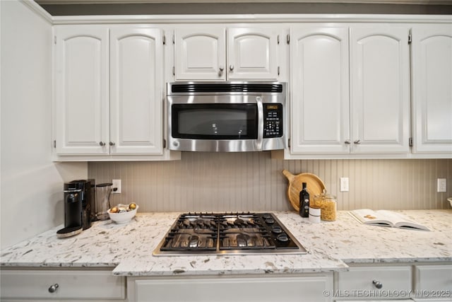 5117 E 92nd St, Tulsa, OK 74137 - kitchen with appliances with stainless steel finishes, white cabinetry, and light stone countertops