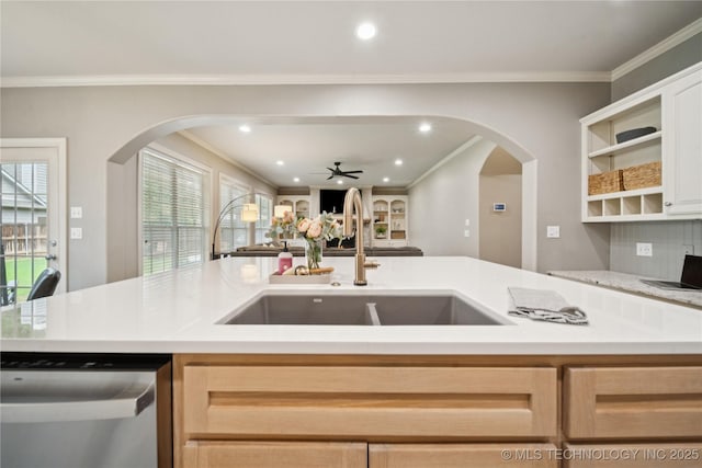 5117 E 92nd St, Tulsa, OK 74137 - kitchen with stainless steel dishwasher, open floor plan, crown molding, light countertops, and arched walkways