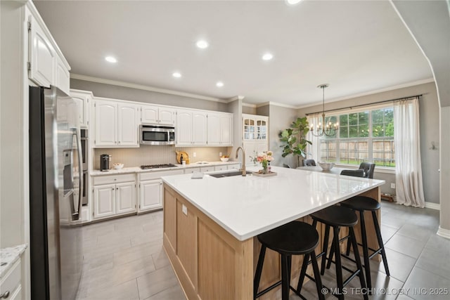 5117 E 92nd St, Tulsa, OK 74137 - kitchen with appliances with stainless steel finishes, light tile patterned floors, a chandelier, white cabinets, and recessed lighting