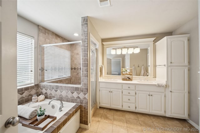 5117 E 92nd St, Tulsa, OK 74137 - bathroom featuring double vanity, a stall shower, a garden tub, tile patterned floors, and recessed lighting