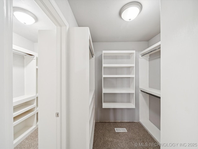 5607 E 76th St, Tulsa, OK 74136 - spacious closet featuring dark colored carpet