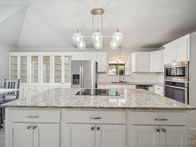 5607 E 76th St, Tulsa, OK 74136 - kitchen with stainless steel appliances, a kitchen island, white cabinetry, decorative backsplash, and hanging light fixtures