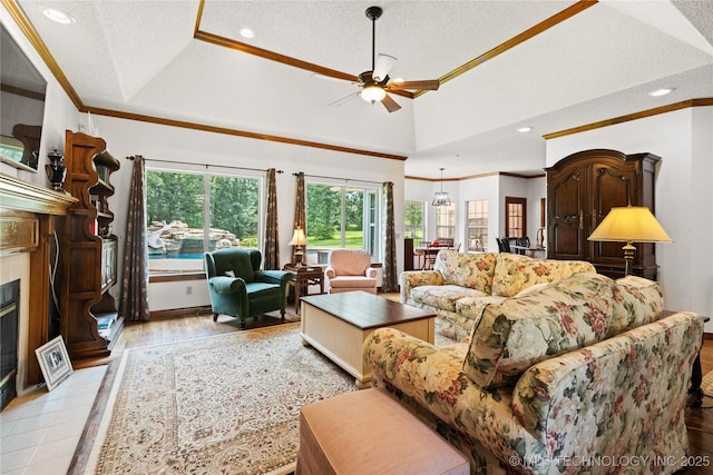 501 W 35th Pl, Sand Springs, OK 74063 - living room with ornamental molding, a textured ceiling, a ceiling fan, a glass covered fireplace, and recessed lighting
