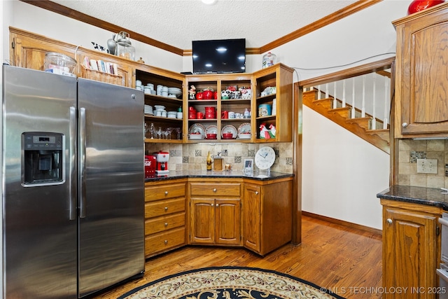 501 W 35th Pl, Sand Springs, OK 74063 - kitchen with stainless steel fridge with ice dispenser, ornamental molding, wood finished floors, backsplash, and brown cabinetry