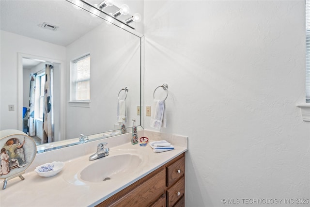 501 W 35th Pl, Sand Springs, OK 74063 - bathroom featuring vanity and a textured wall